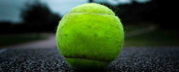 closeup of tennis ball on pavement