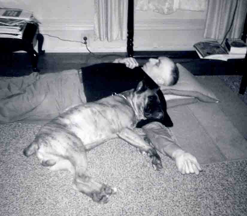 Grandfather and dog sleeping on floor.